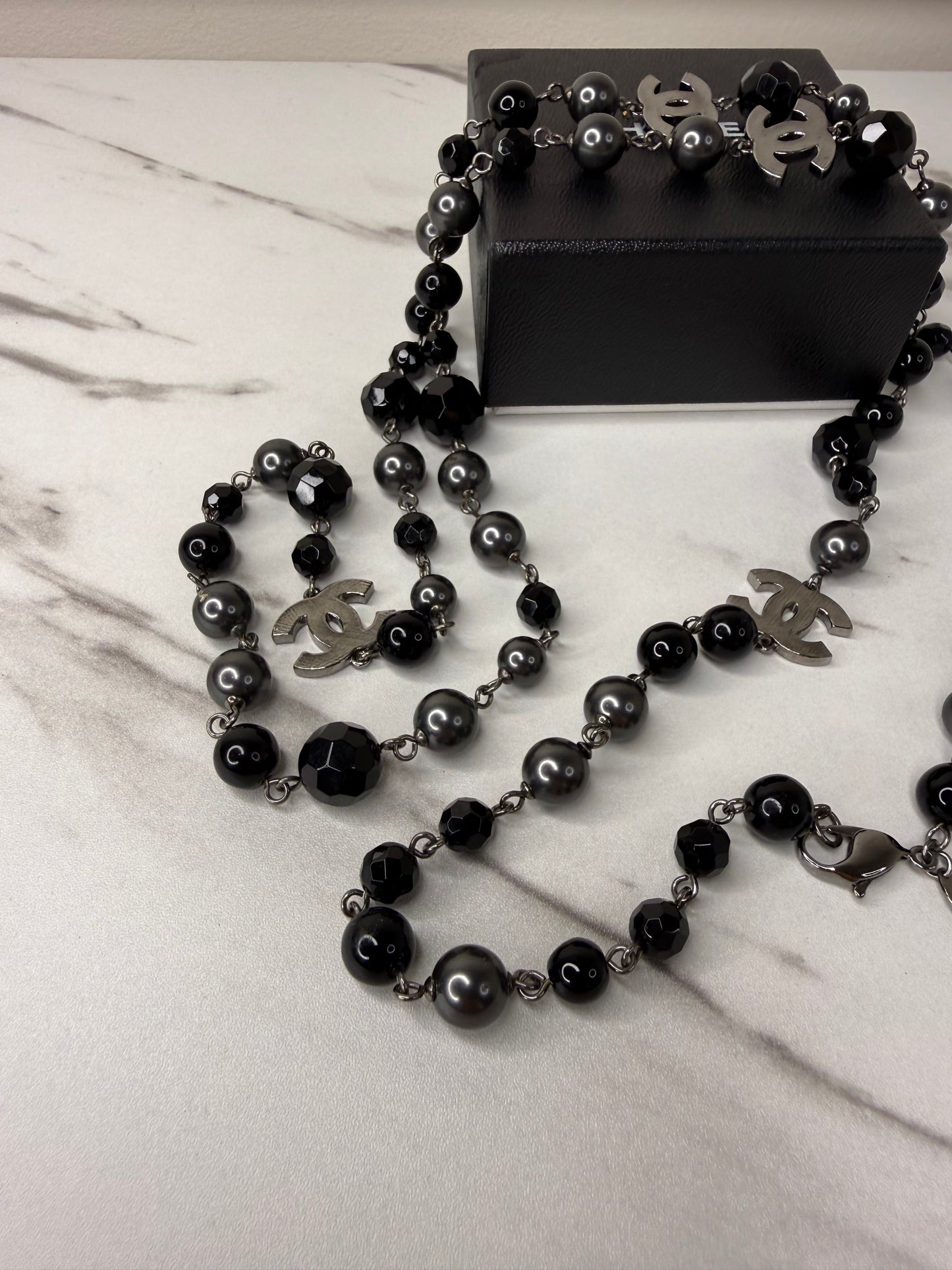 Chanel CC Logo long necklace featuring black and grey beads