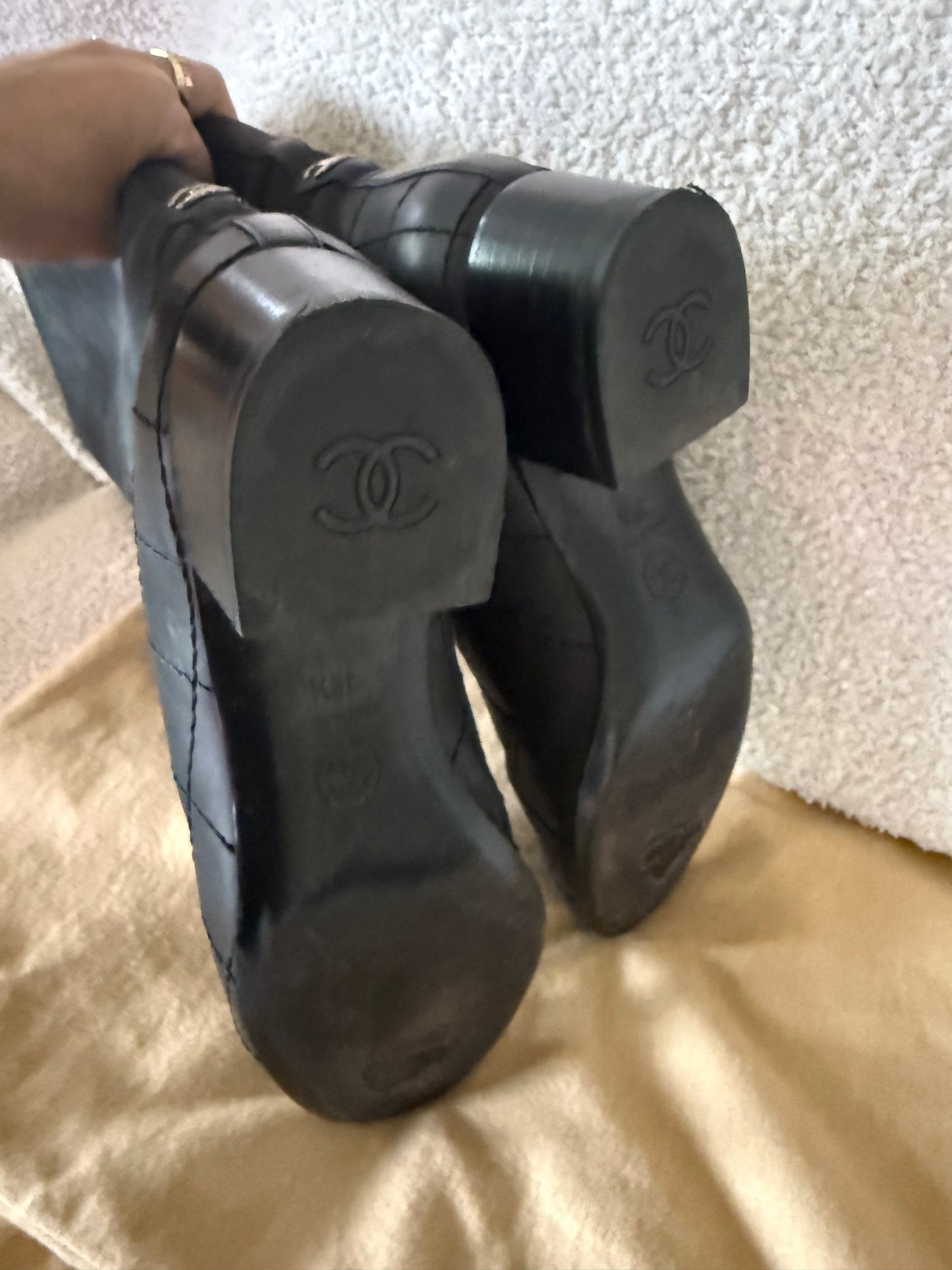 Chanel black tall riding boots featuring quilted leather details and a CC logo