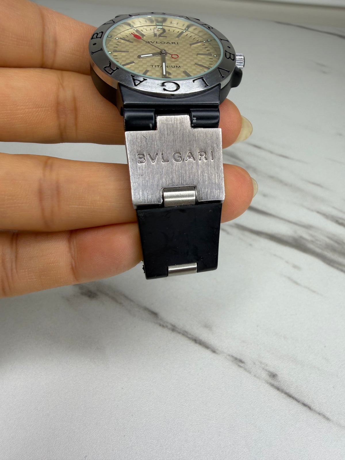 Bvlgari Diagono Titanium Automatic Watch with a cream dial and black rubber strap.