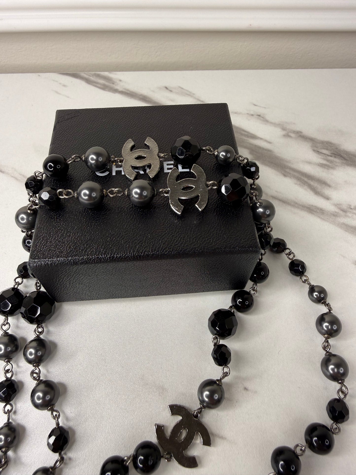 Chanel CC Logo long necklace featuring black and grey beads