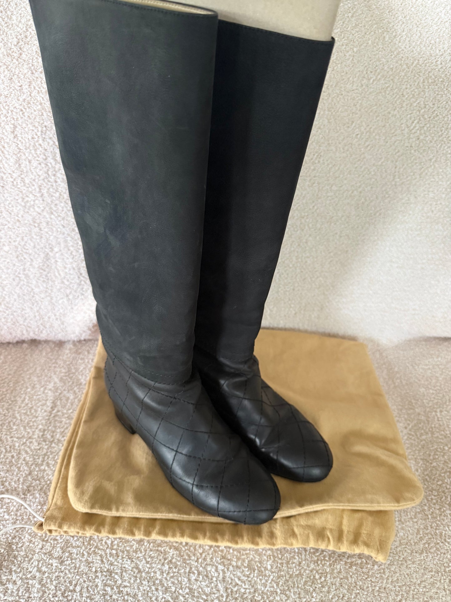 Chanel black tall riding boots featuring quilted leather details and a CC logo