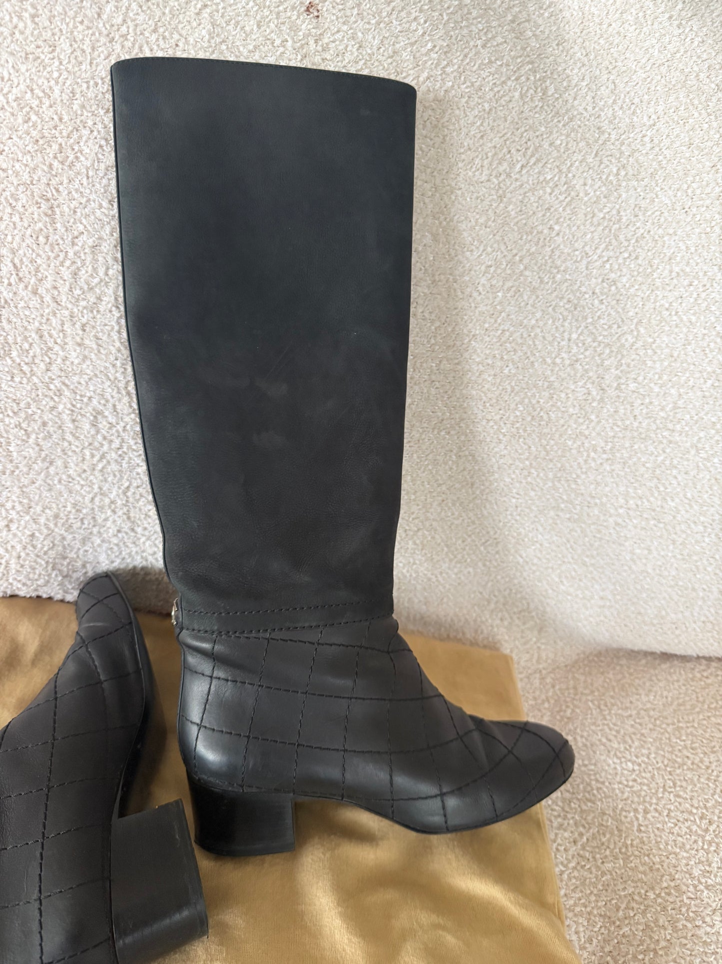 Chanel black tall riding boots featuring quilted leather details and a CC logo