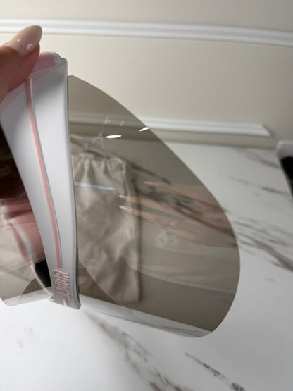 Dior Club 1 sun visor in pink and white with a grey lens