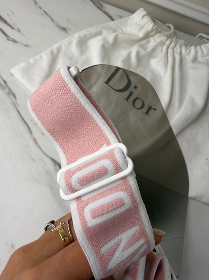 Dior Club 1 sun visor in pink and white with a grey lens