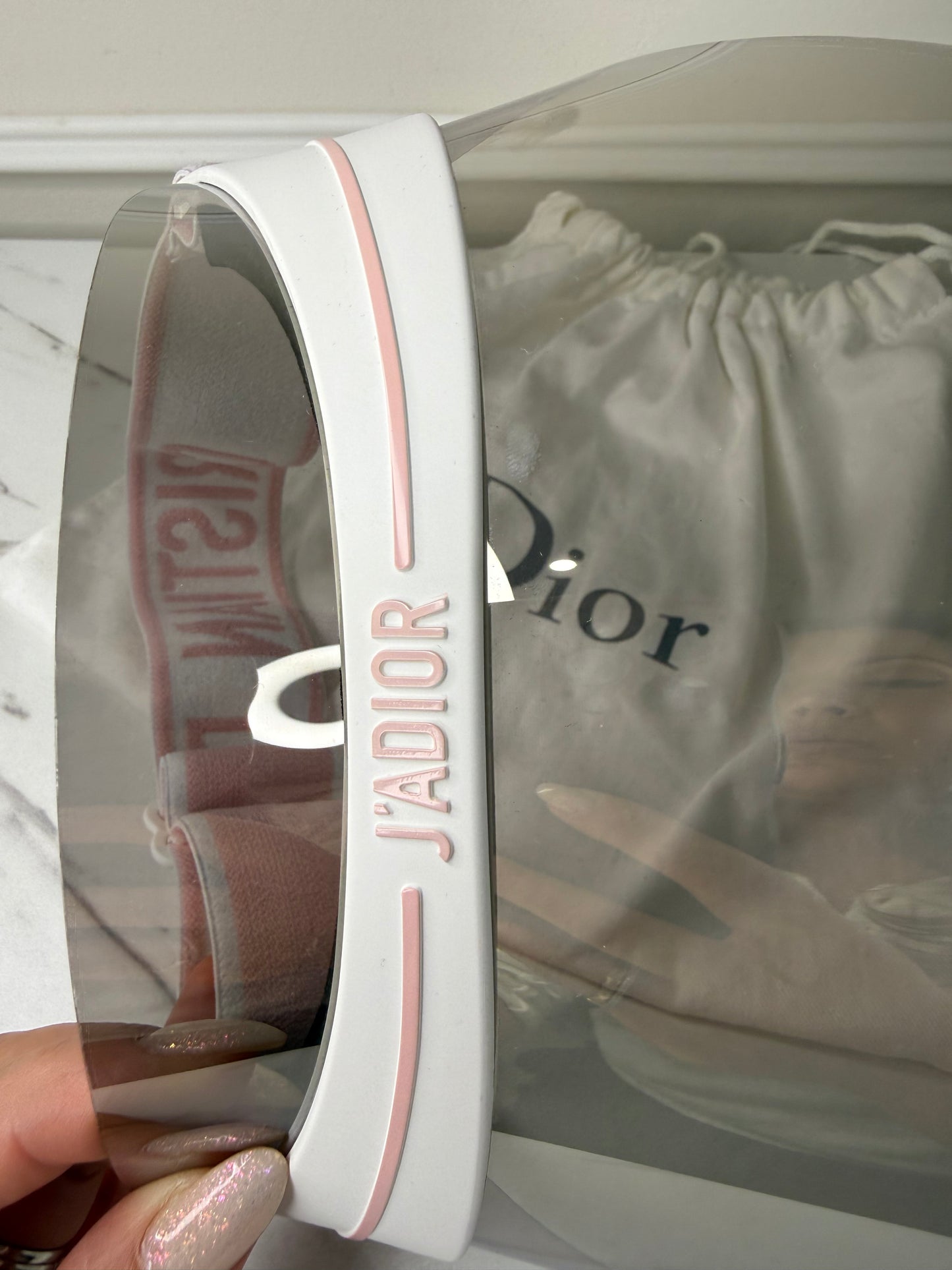 Dior Club 1 sun visor in pink and white with a grey lens