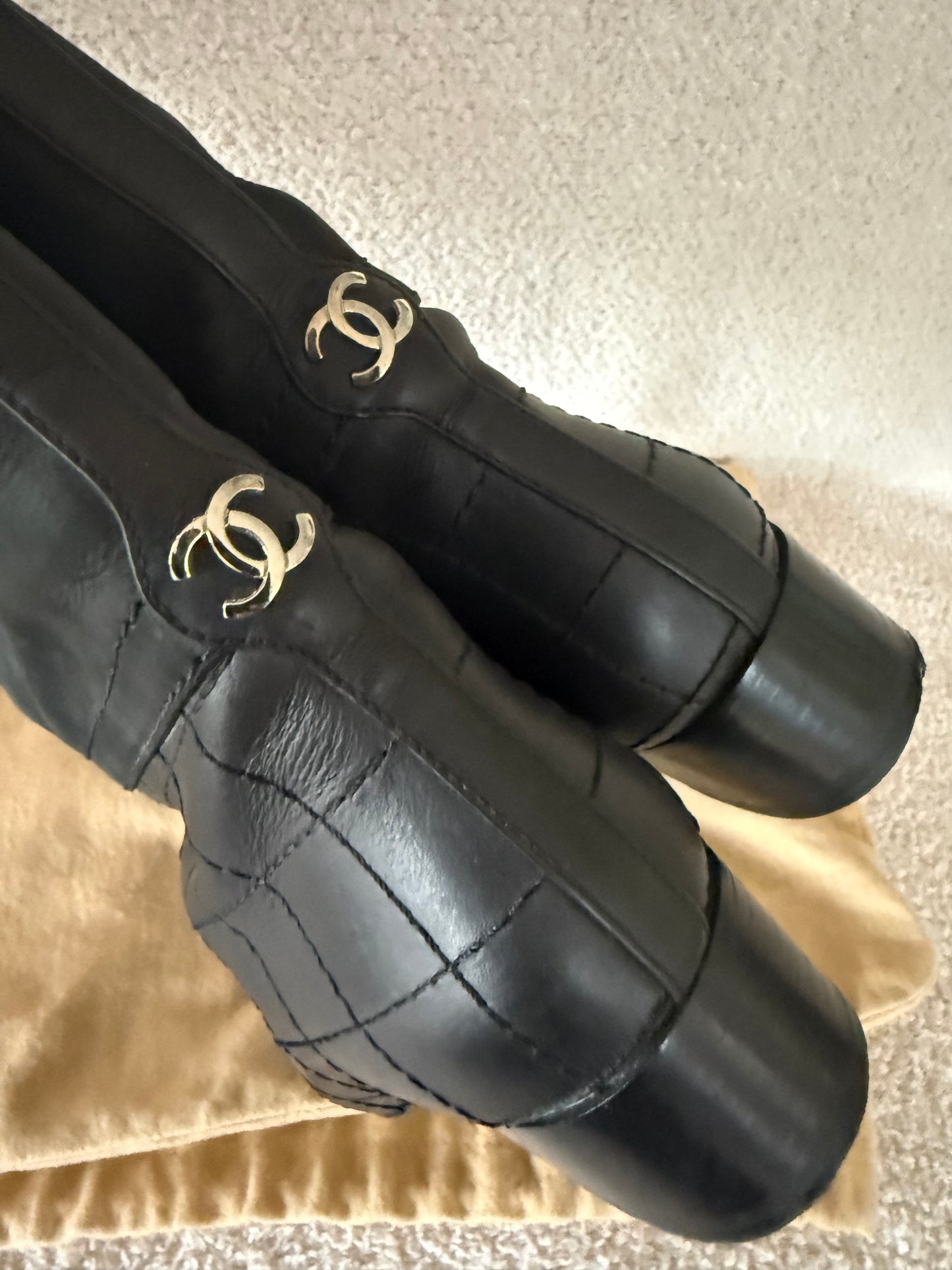 Chanel black tall riding boots featuring quilted leather details and a CC logo