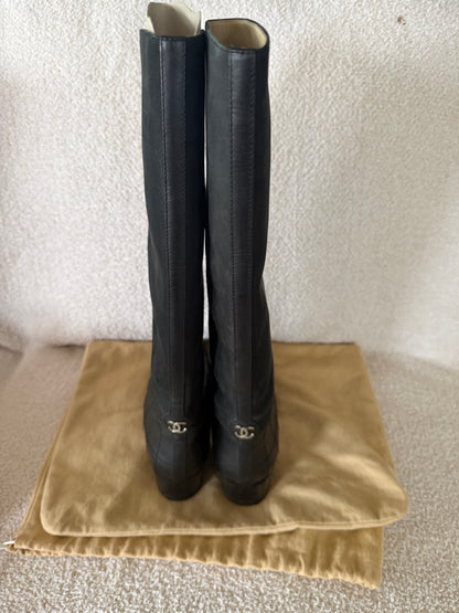 Chanel black tall riding boots featuring quilted leather details and a CC logo
