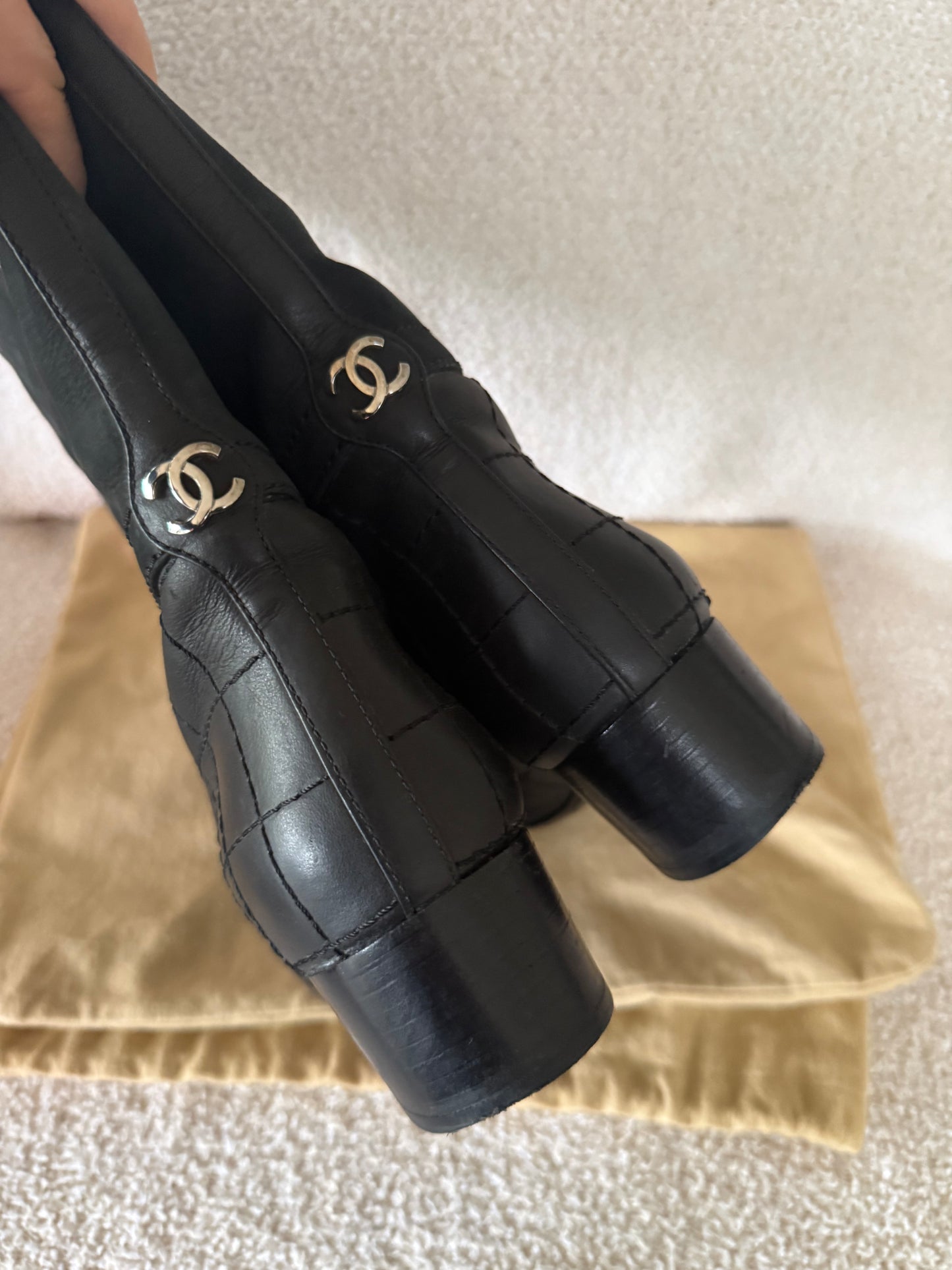 Chanel black tall riding boots featuring quilted leather details and a CC logo
