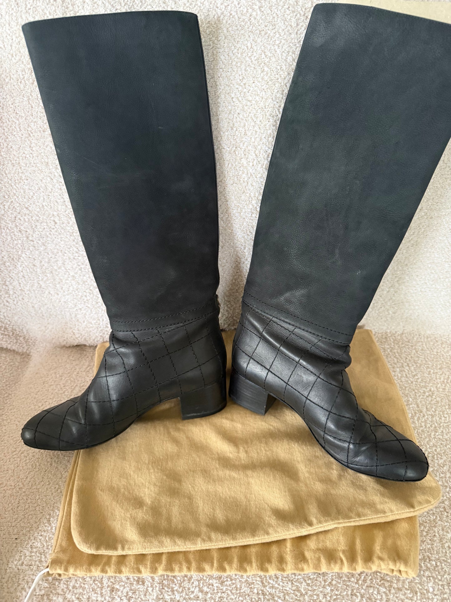 Chanel black tall riding boots featuring quilted leather details and a CC logo