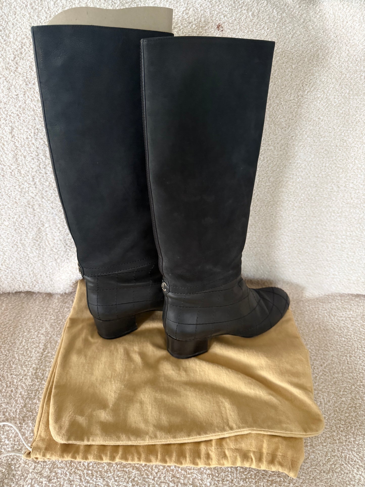 Chanel black tall riding boots featuring quilted leather details and a CC logo