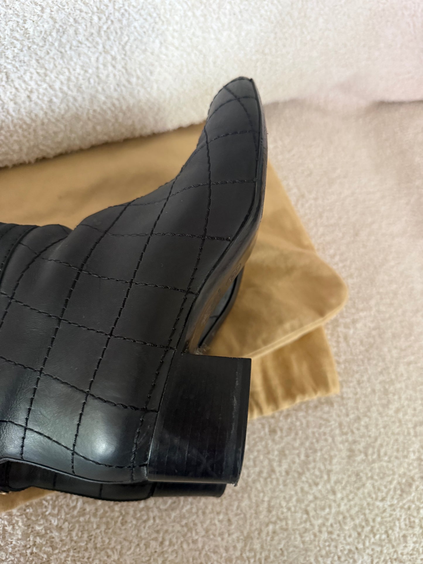 Chanel black tall riding boots featuring quilted leather details and a CC logo