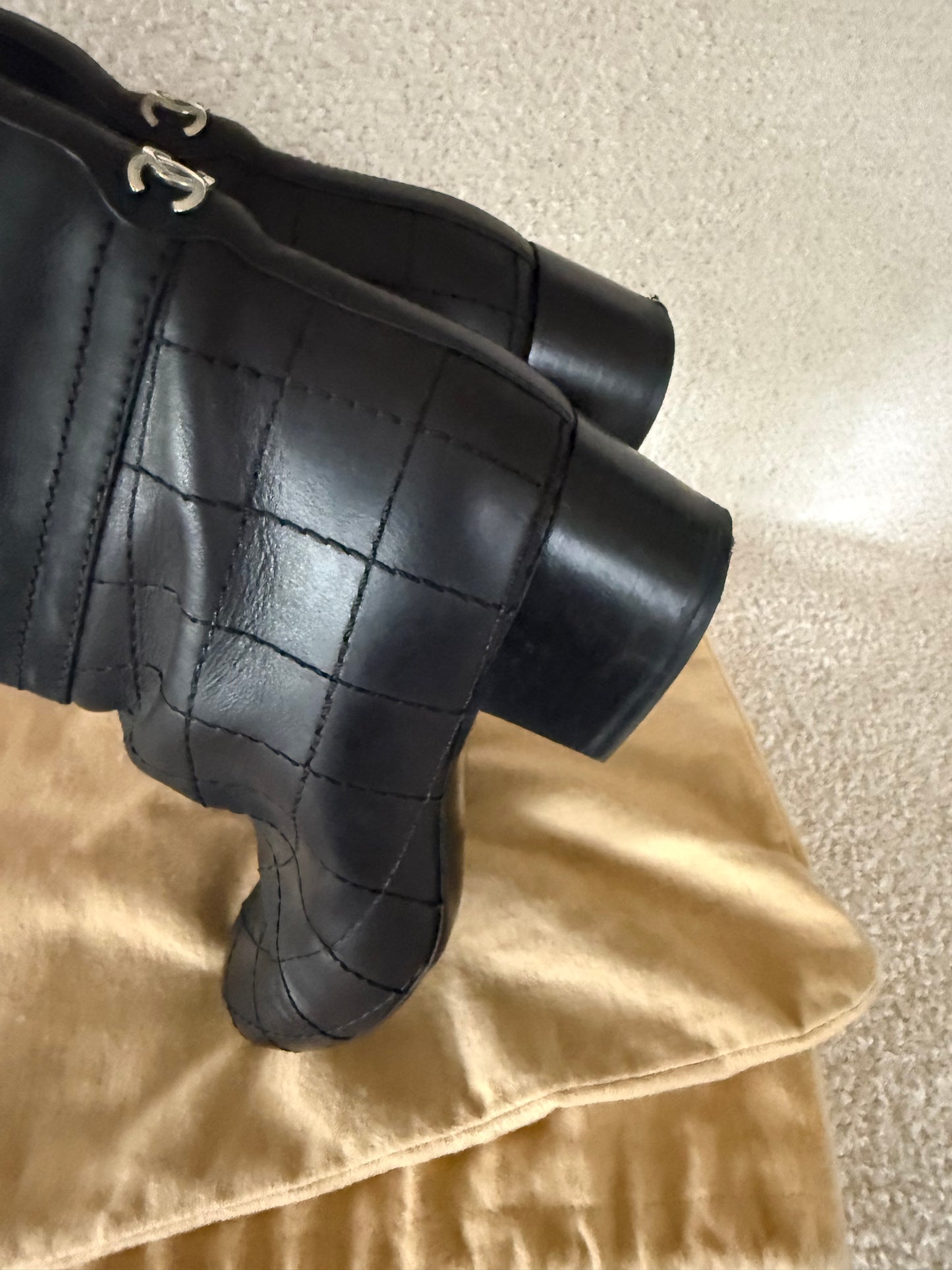 Chanel black tall riding boots featuring quilted leather details and a CC logo