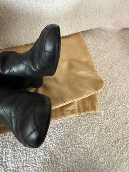 Chanel black tall riding boots featuring quilted leather details and a CC logo