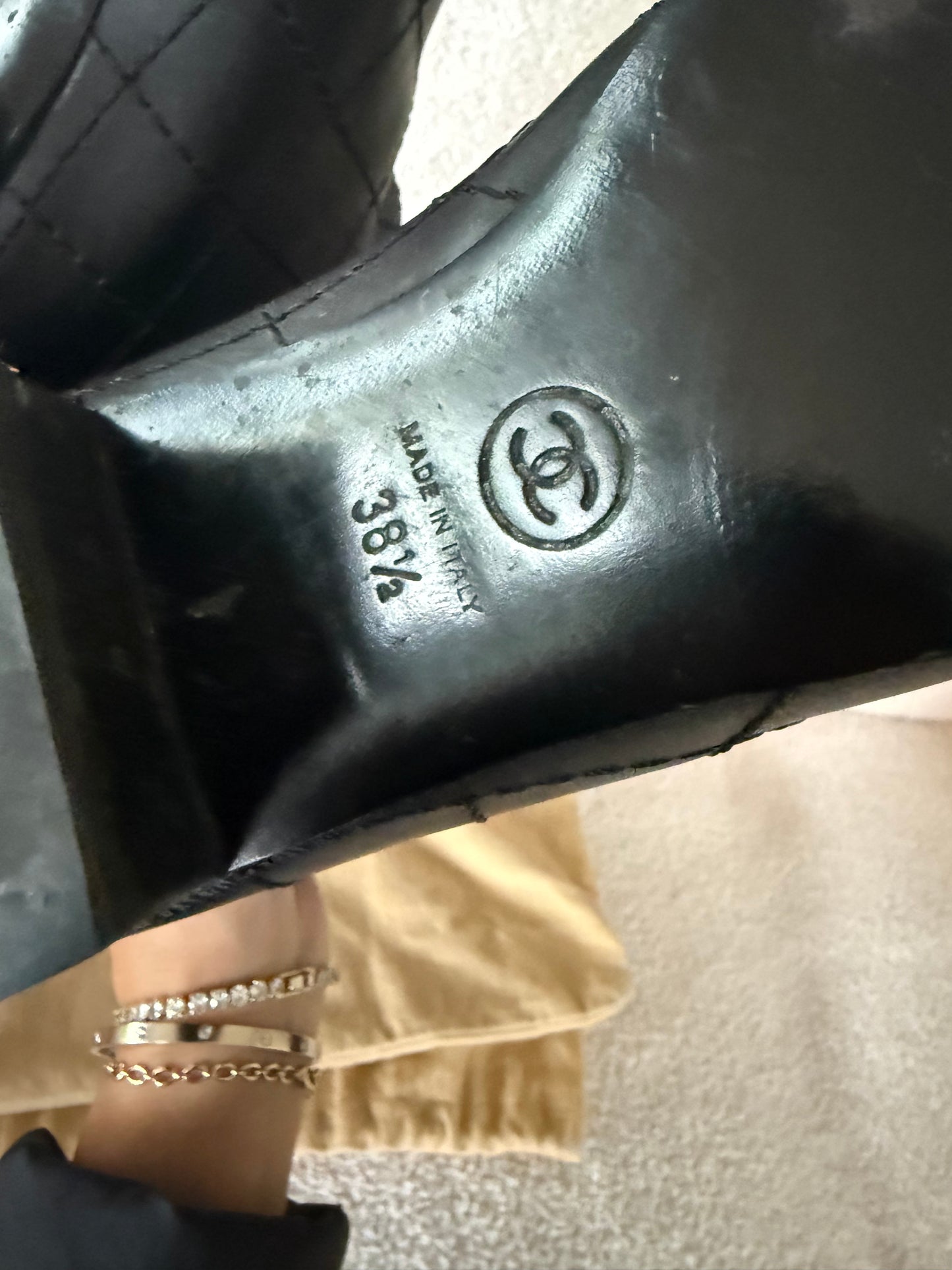 Chanel black tall riding boots featuring quilted leather details and a CC logo